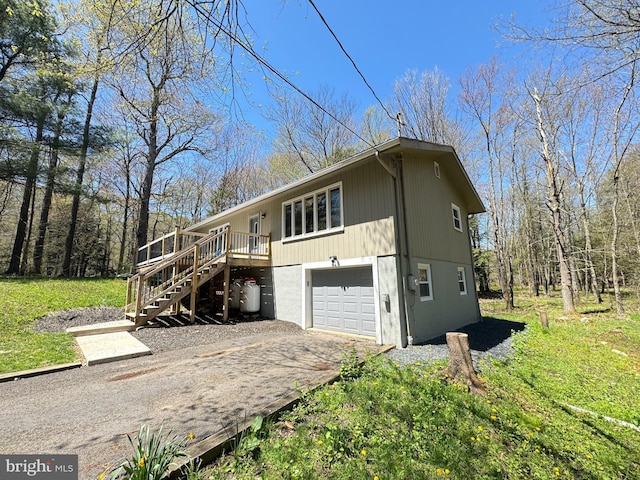 view of home's exterior featuring a garage and a deck