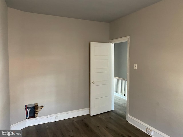 empty room featuring dark hardwood / wood-style flooring