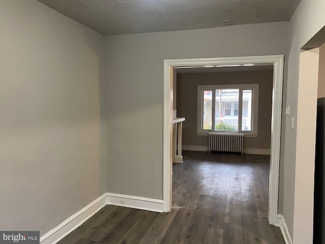 hall featuring dark wood-type flooring and radiator