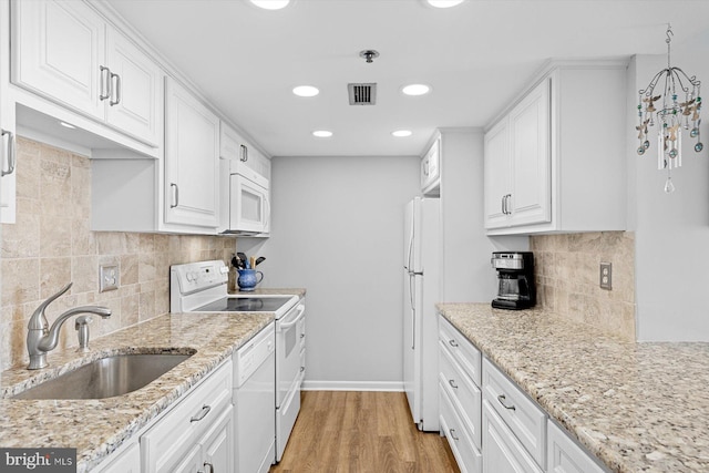 kitchen with light wood-type flooring, white appliances, sink, and white cabinets