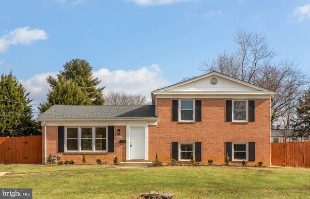 tri-level home featuring a front lawn