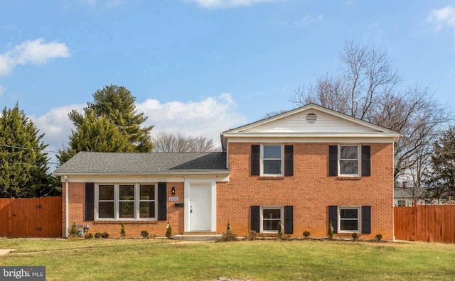 tri-level home with a front lawn