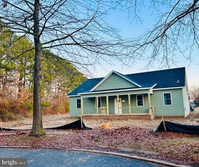 rear view of property featuring a porch