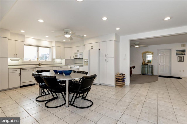 tiled dining area with sink and ceiling fan