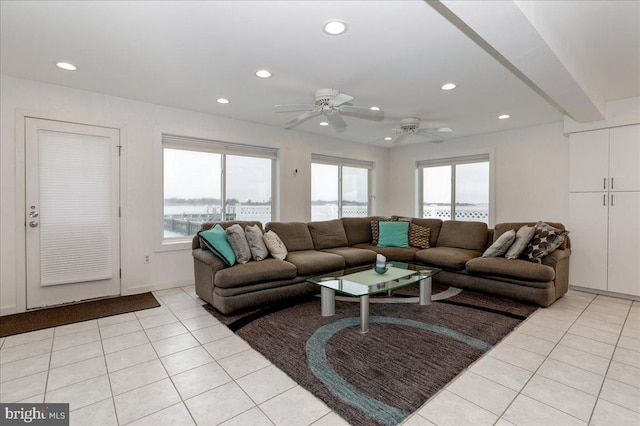 tiled living room featuring ceiling fan and a wealth of natural light