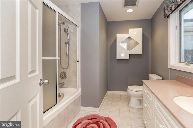 full bathroom with tile patterned flooring, vanity, combined bath / shower with glass door, and toilet