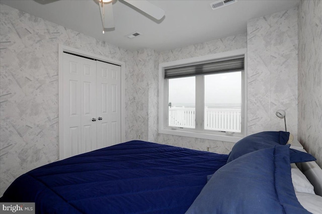 bedroom with ceiling fan and a closet