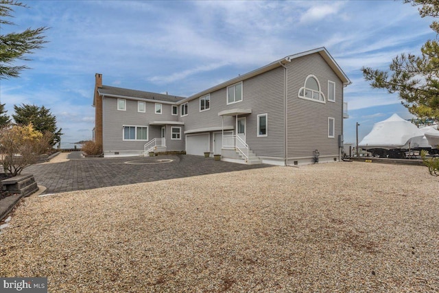 back of house with a garage