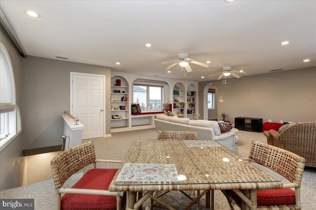 dining area featuring carpet flooring, built in features, and ceiling fan