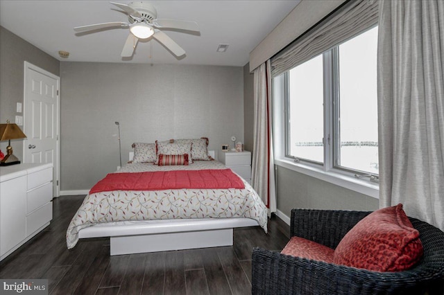 bedroom with dark wood-type flooring and ceiling fan