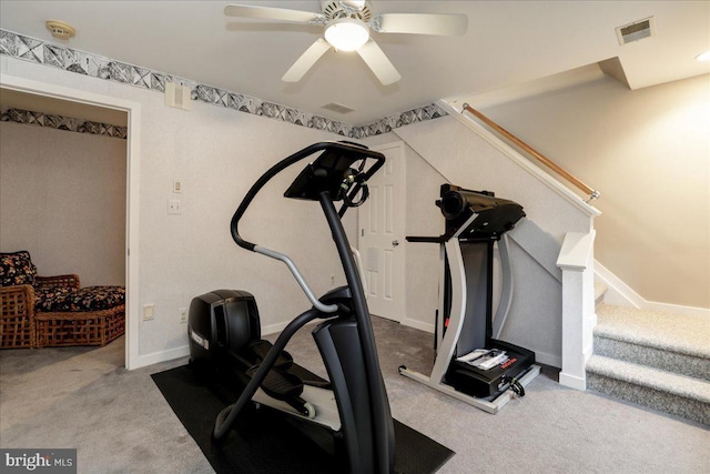 exercise area featuring light colored carpet and ceiling fan