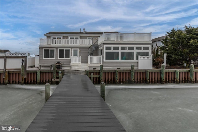 back of property featuring a balcony