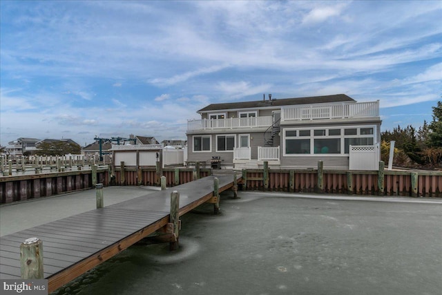 rear view of property with a water view