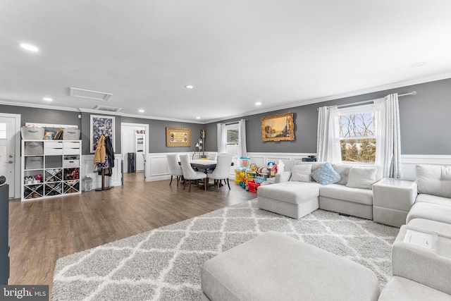 living room featuring a wainscoted wall, ornamental molding, wood finished floors, and recessed lighting