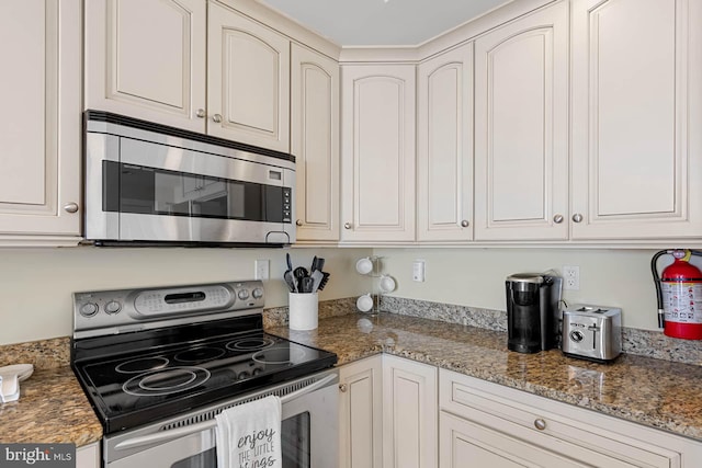 kitchen with white cabinetry and appliances with stainless steel finishes