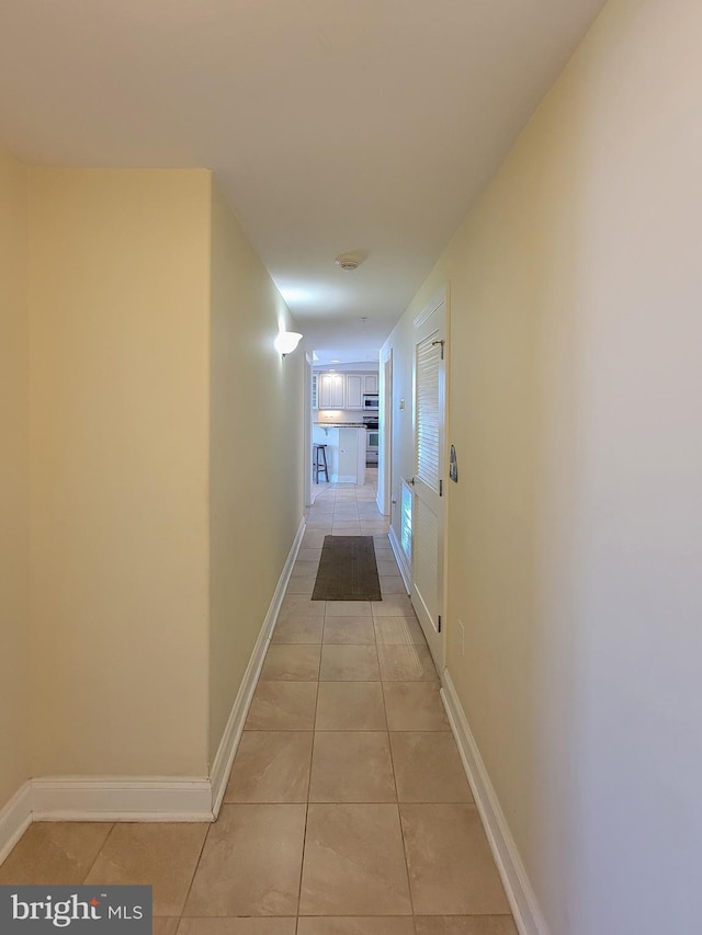 hallway with light tile patterned floors