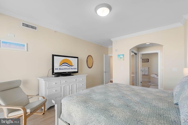 bedroom with connected bathroom, crown molding, and light hardwood / wood-style floors