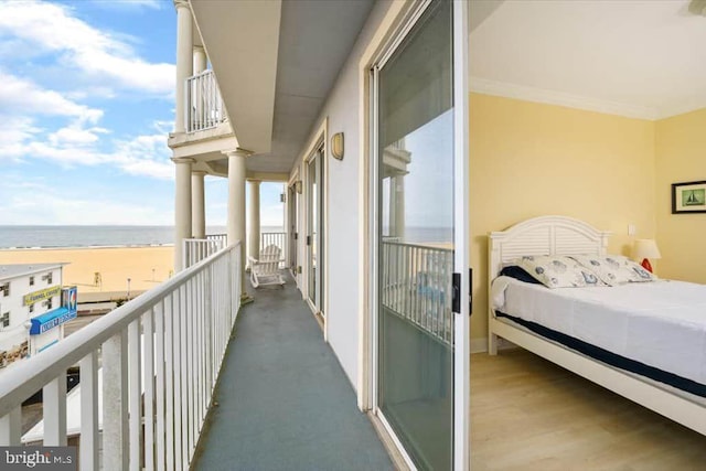 balcony with a water view and a beach view