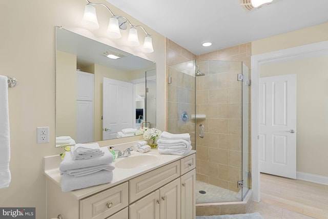 bathroom with tile patterned flooring, vanity, and an enclosed shower