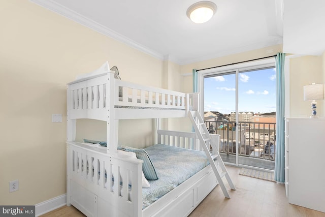 bedroom with crown molding, access to exterior, and light hardwood / wood-style floors