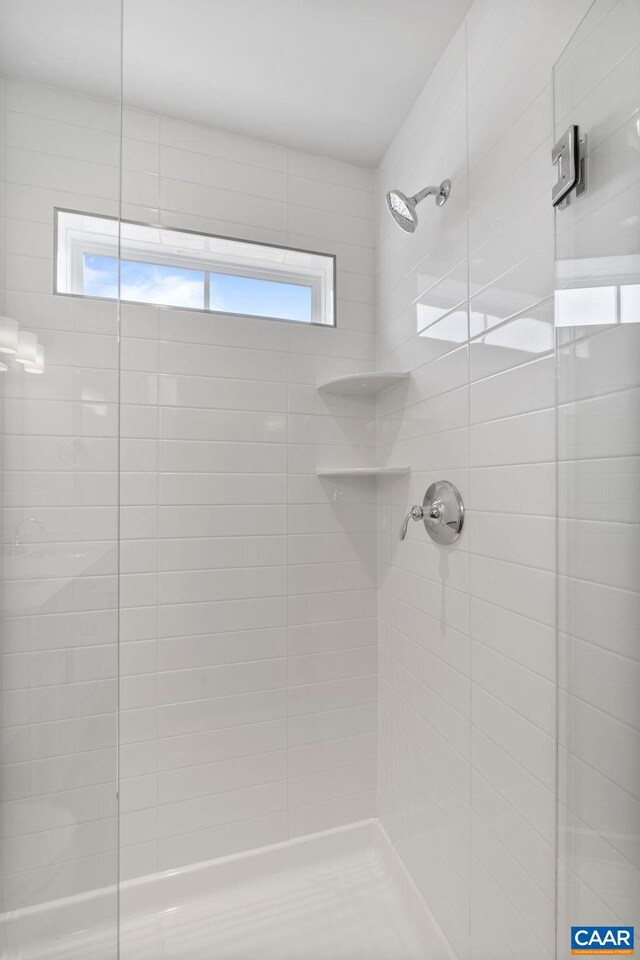 bathroom with tiled shower