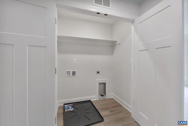 clothes washing area with hookup for a washing machine, hookup for an electric dryer, and light hardwood / wood-style floors