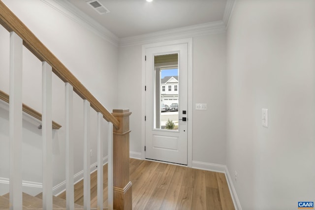 entryway featuring crown molding and light hardwood / wood-style floors