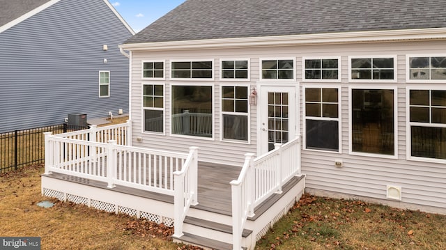 wooden terrace with central AC unit and fence