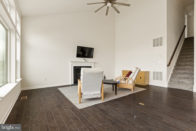 unfurnished room featuring dark hardwood / wood-style floors, ceiling fan, and a high ceiling