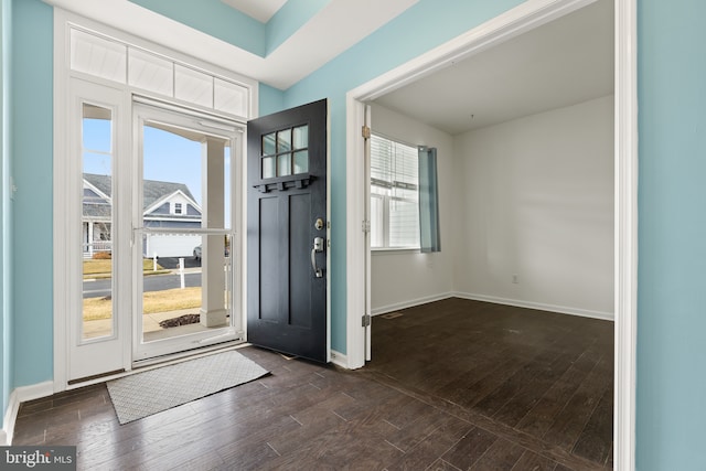 foyer entrance featuring dark wood-type flooring and plenty of natural light