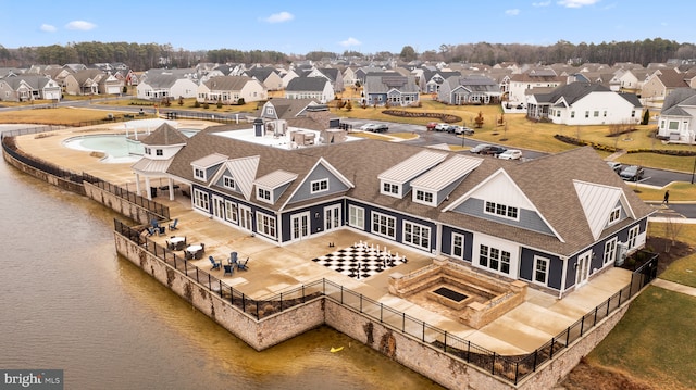 drone / aerial view featuring a water view and a residential view