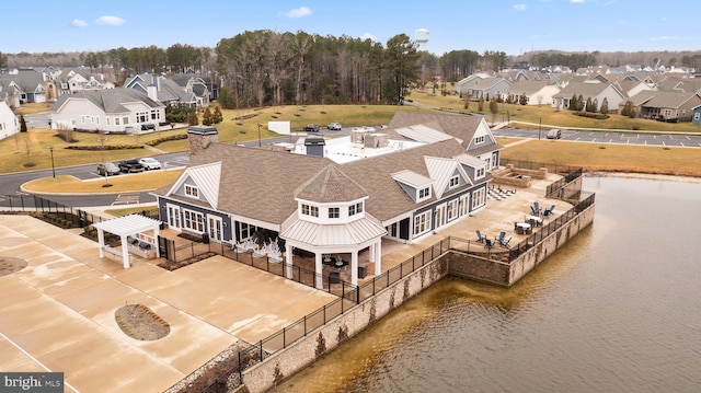 bird's eye view with a residential view and a water view