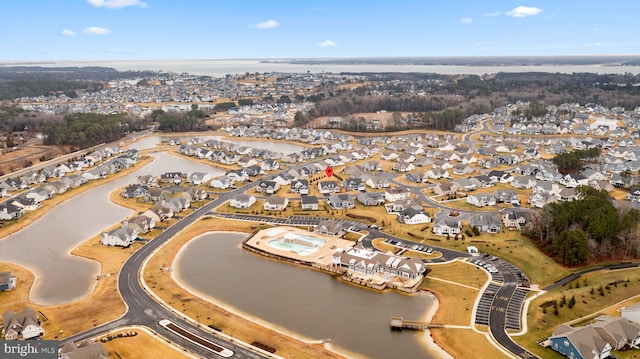 drone / aerial view featuring a residential view and a water view