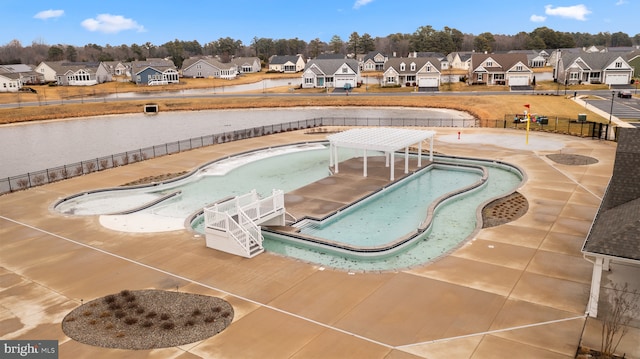 view of pool with a residential view and fence