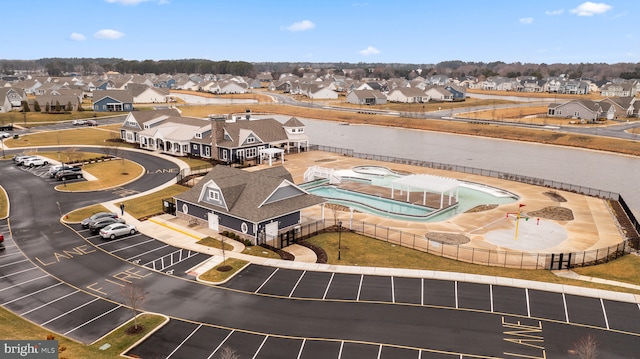 birds eye view of property with a residential view and a water view