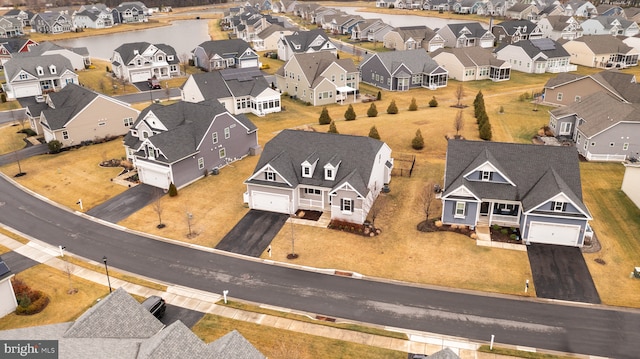 bird's eye view featuring a water view and a residential view