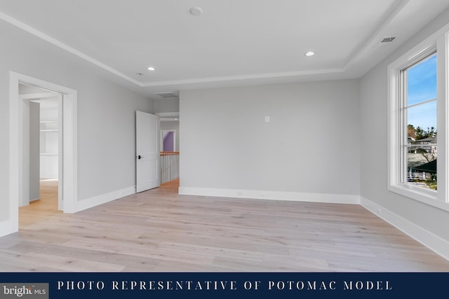 empty room featuring baseboards, visible vents, light wood-style floors, and recessed lighting