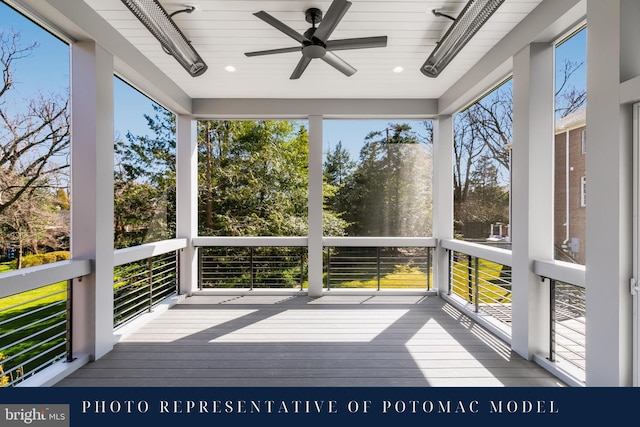 unfurnished sunroom with ceiling fan