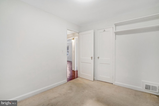 unfurnished bedroom featuring light colored carpet