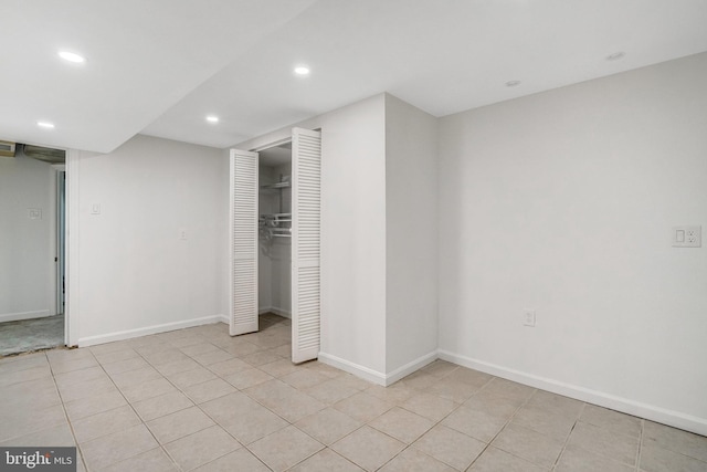 unfurnished bedroom featuring light tile patterned floors and a closet