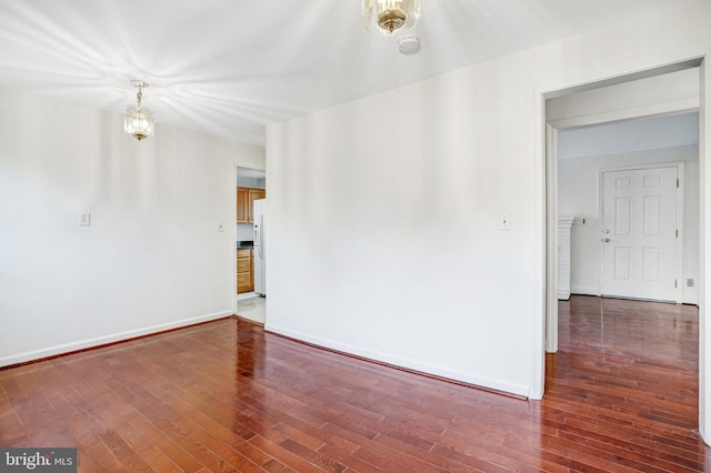 spare room featuring dark hardwood / wood-style floors