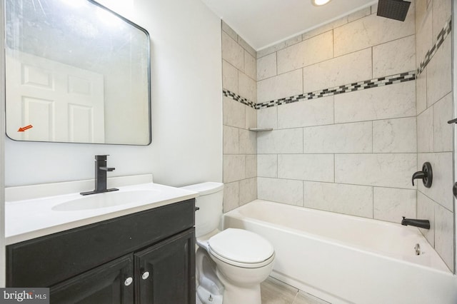 full bathroom featuring tiled shower / bath combo, vanity, and toilet