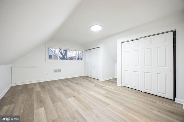 bonus room with vaulted ceiling and light hardwood / wood-style flooring