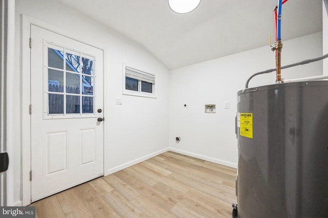 washroom featuring electric dryer hookup, hookup for a washing machine, light hardwood / wood-style flooring, and electric water heater