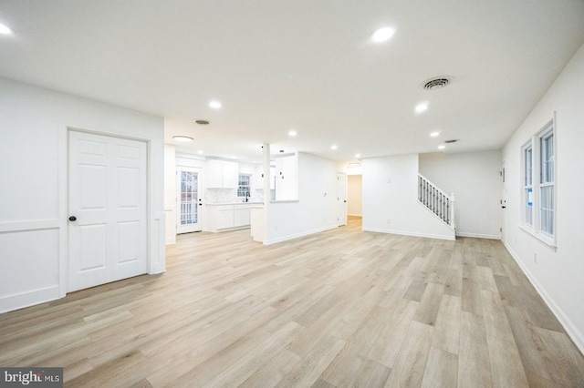 unfurnished living room with light hardwood / wood-style floors