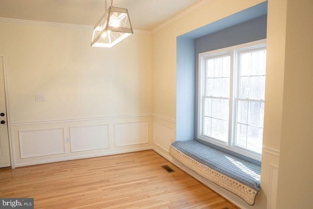 interior space featuring ornamental molding and light hardwood / wood-style flooring