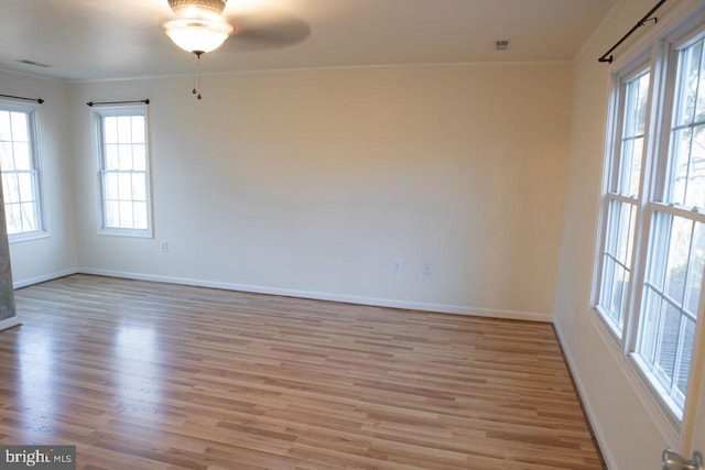 unfurnished room with crown molding, ceiling fan, and light hardwood / wood-style flooring