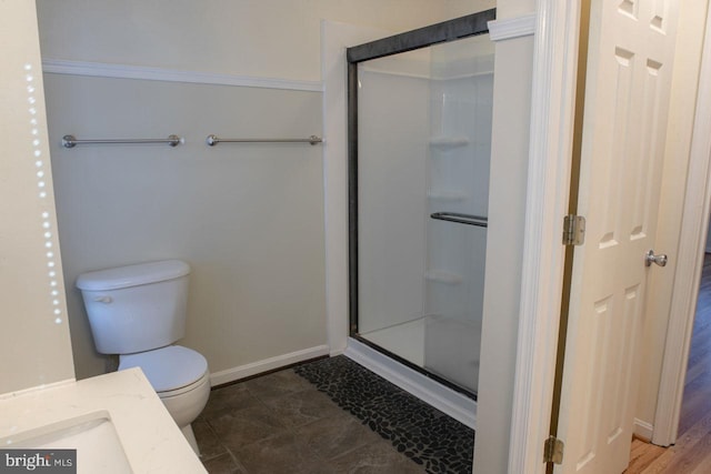 bathroom featuring walk in shower and toilet