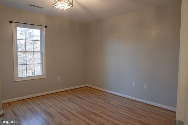 unfurnished room with light wood-type flooring