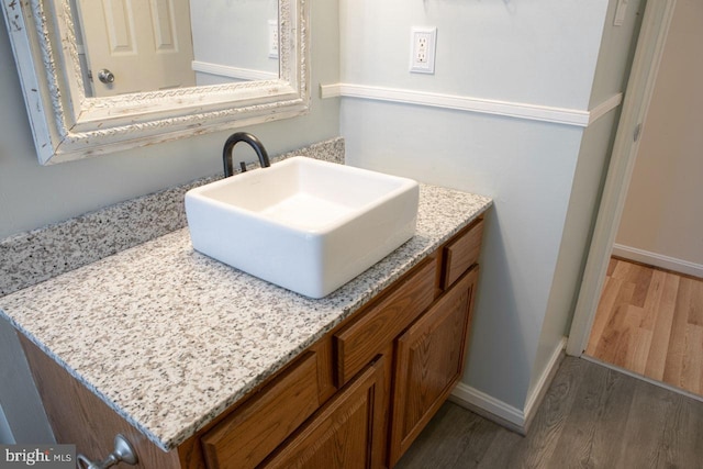 bathroom with vanity and hardwood / wood-style floors